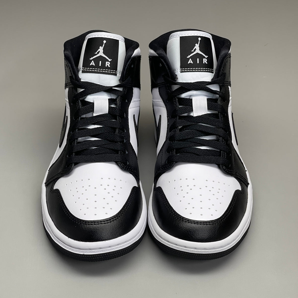 Nike Air Jordan 1 Mid Panda women's shoes in black and white, size 6, featuring classic sneaker design and stylish branding.