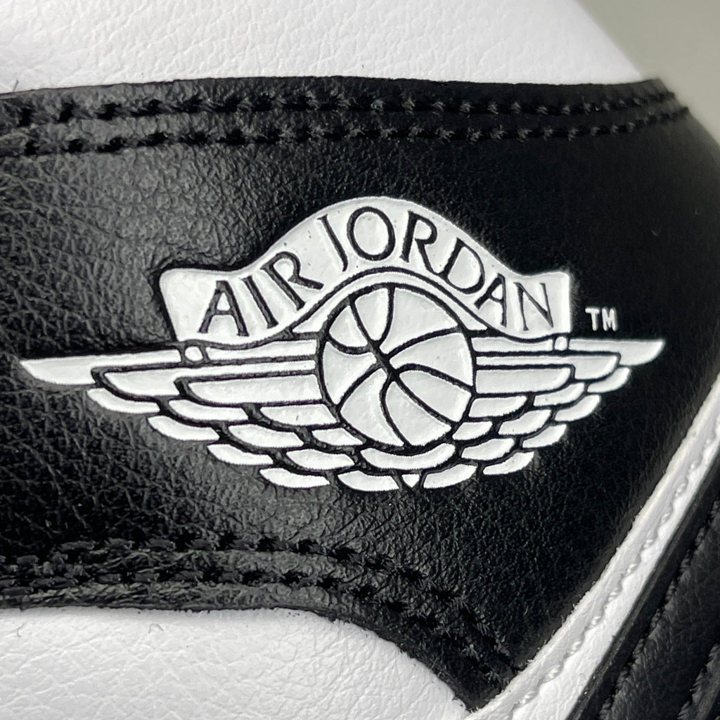Women's Nike Air Jordan 1 Mid Panda sneakers in black and white, size 6, featuring a classic high-top design.