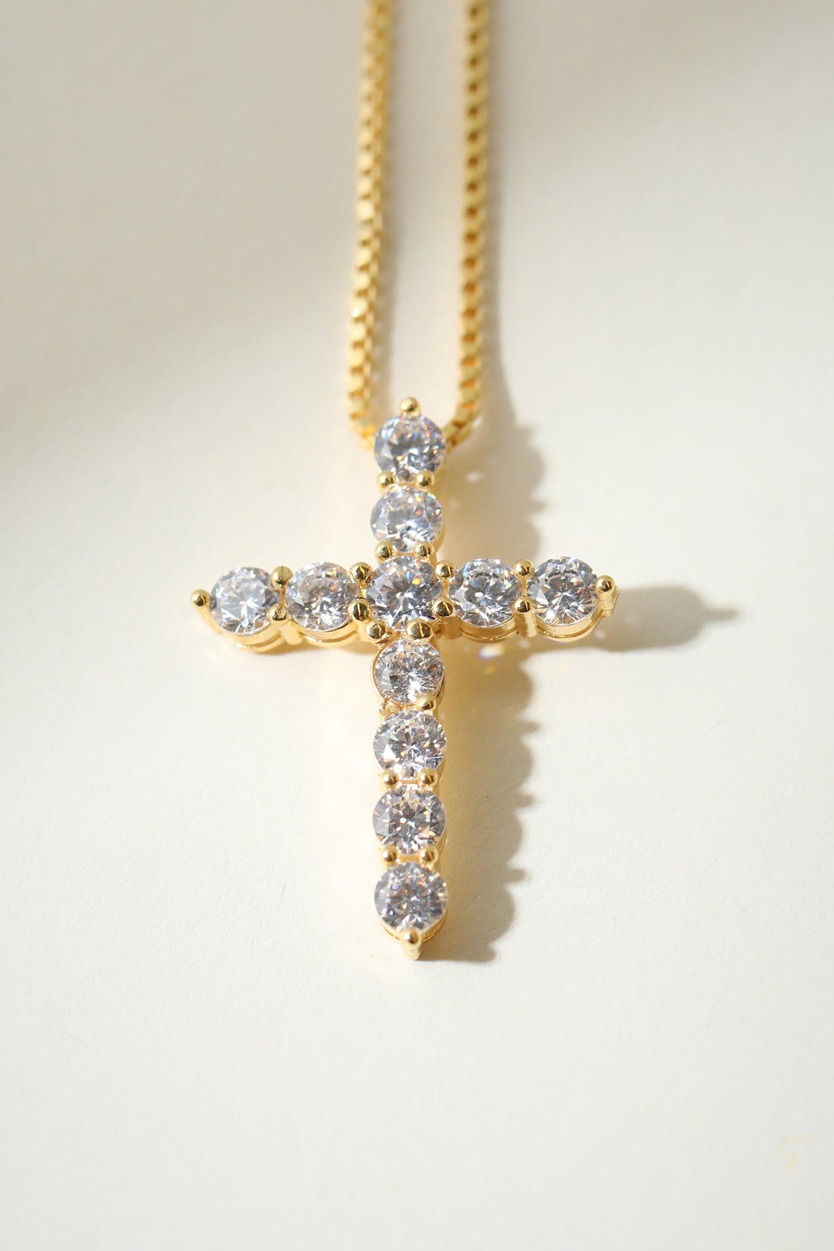 Gold Bella Pavé Cross Pendant featuring sparkling gemstones, religious jewelry piece from The M Jewelers.