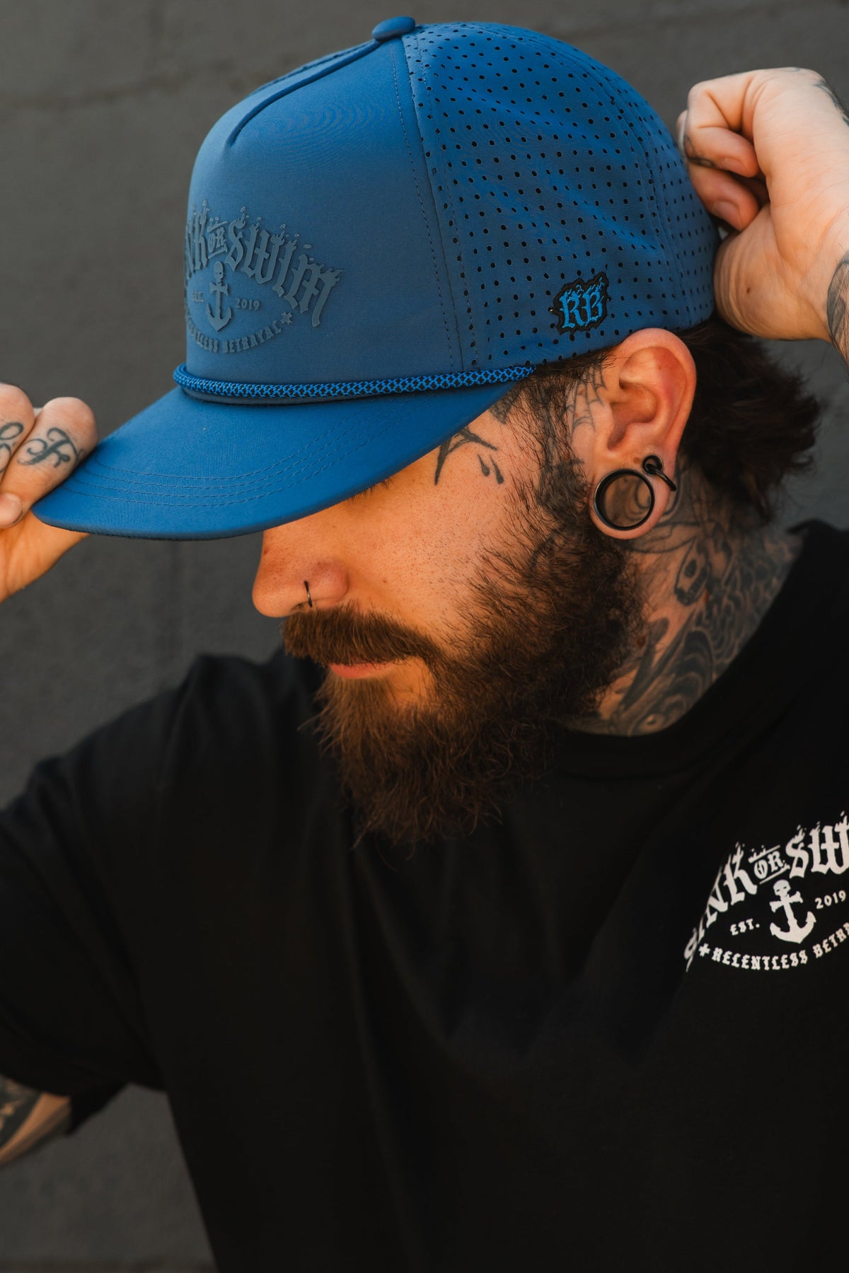 Relentless Betrayal Dark Waters SOS Mute PVC snapback hat with black and dark blue design, adjustable brim and embroidered logo