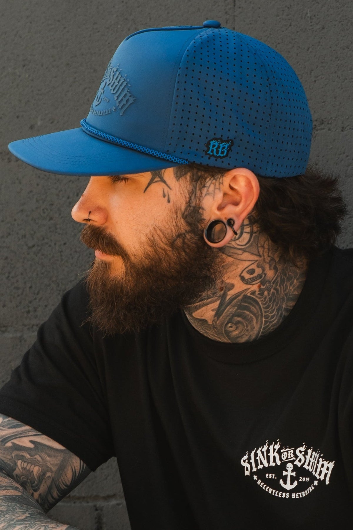 Relentless Betrayal Dark Waters SOS Mute PVC snapback hat with a curved brim and adjustable strap, featuring a dark color and logo embroidery