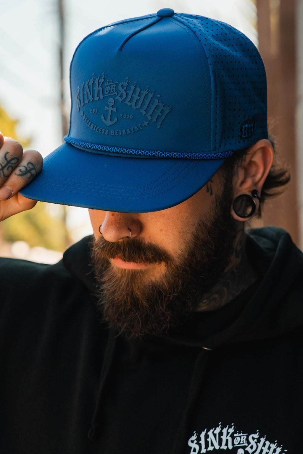 Dark Waters SOS Mute PVC snapback hat by Relentless Betrayal featuring a black design and adjustable brim.