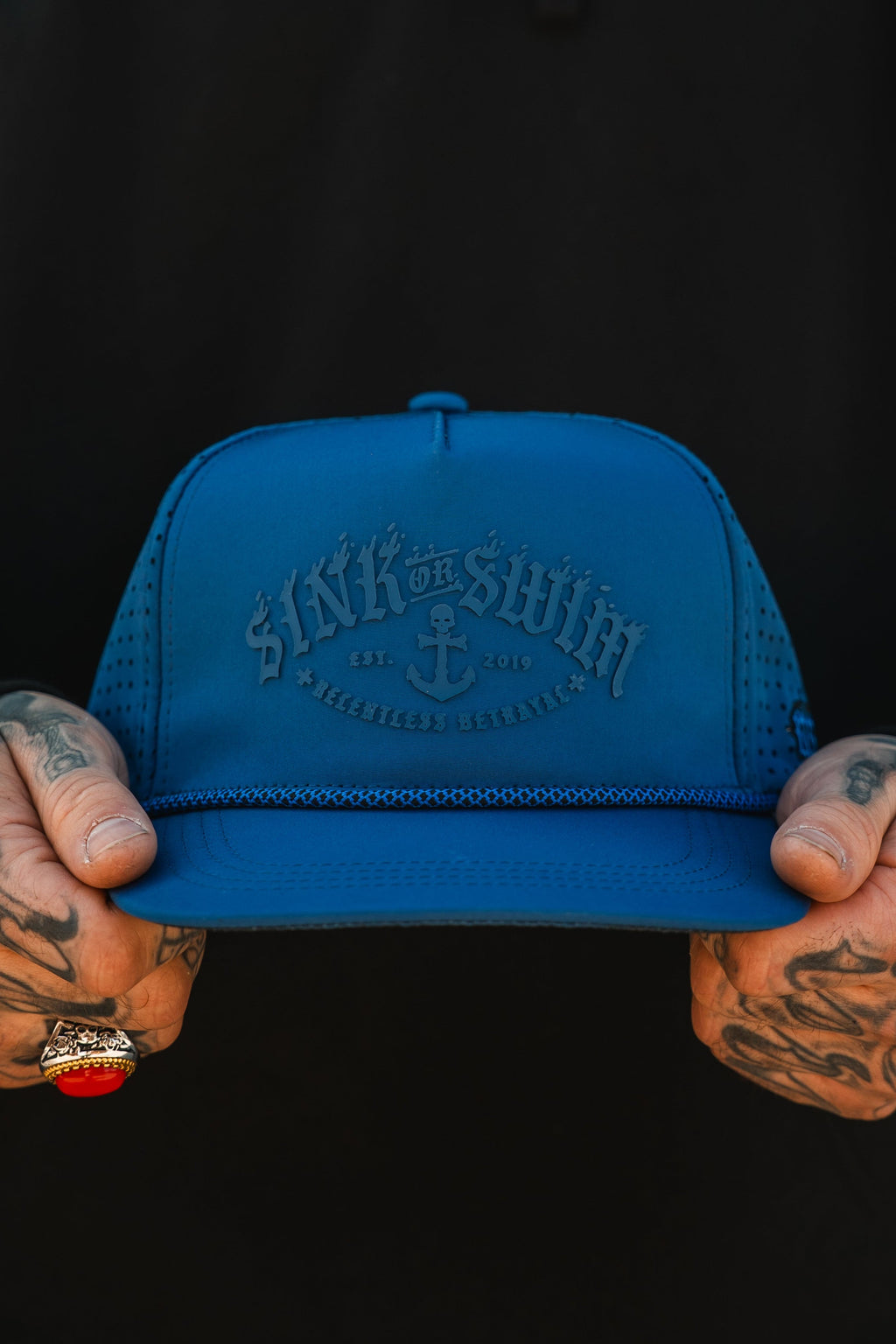 Relentless Betrayal Dark Waters SOS Mute PVC snapback hat with flat brim and bold logo design, front view.