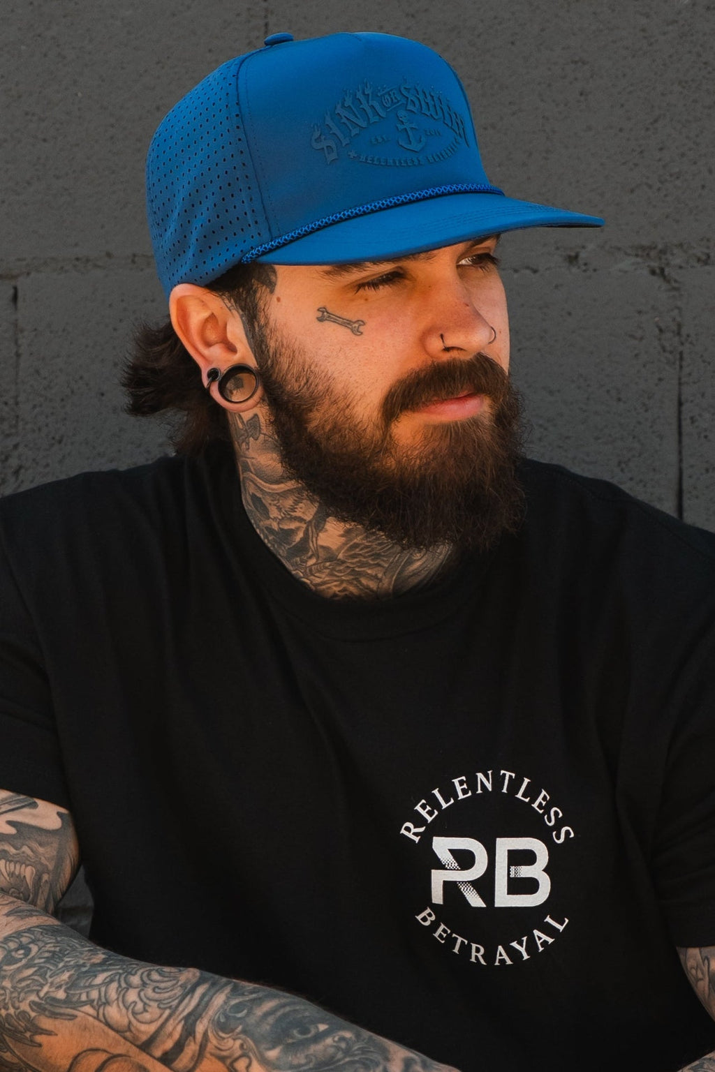 Relentless Betrayal Dark Waters SOS Mute PVC snapback hat with black design and adjustable strap, front logo detail.