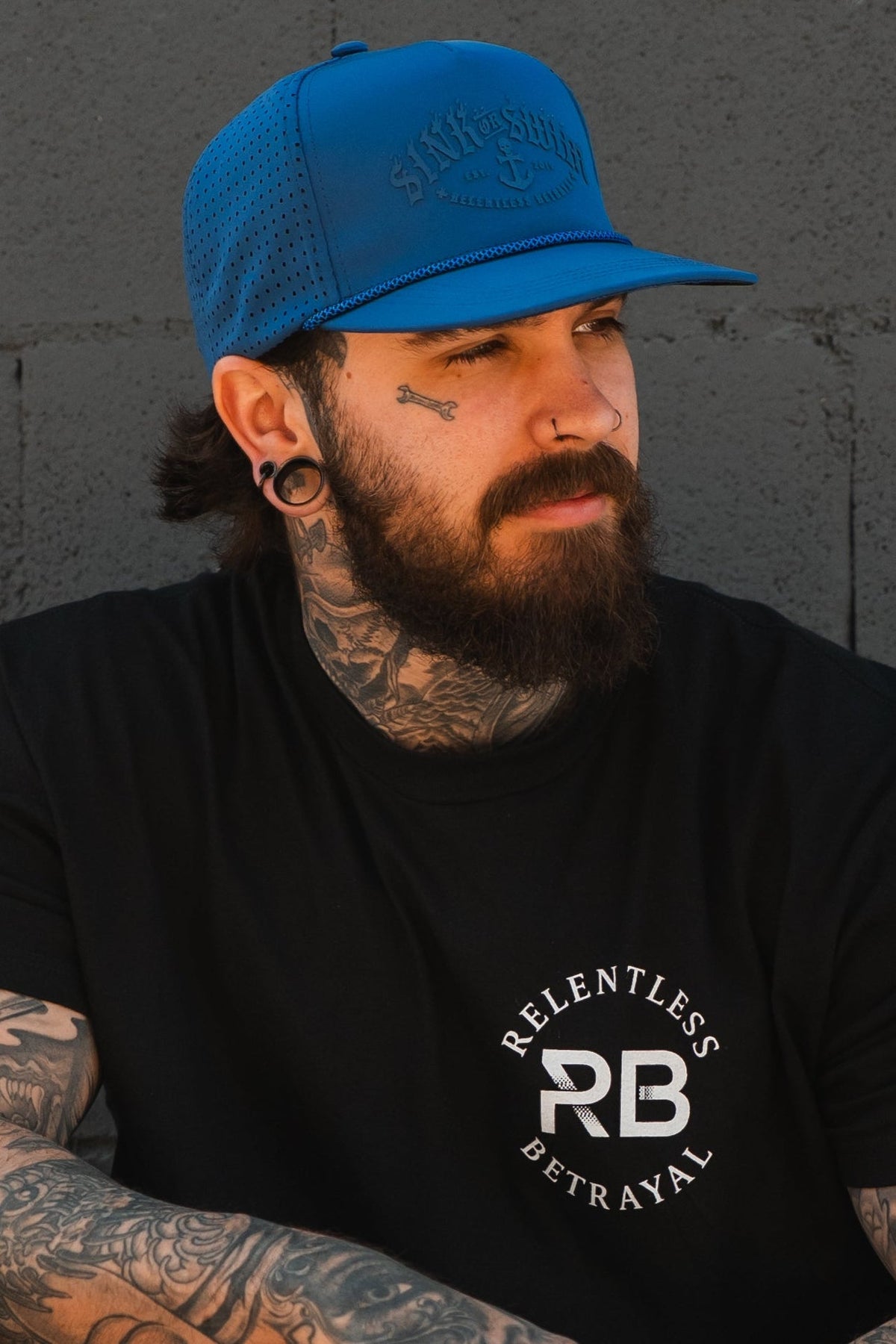 Relentless Betrayal Dark Waters SOS Mute PVC snapback hat with black design and adjustable strap, front logo detail.