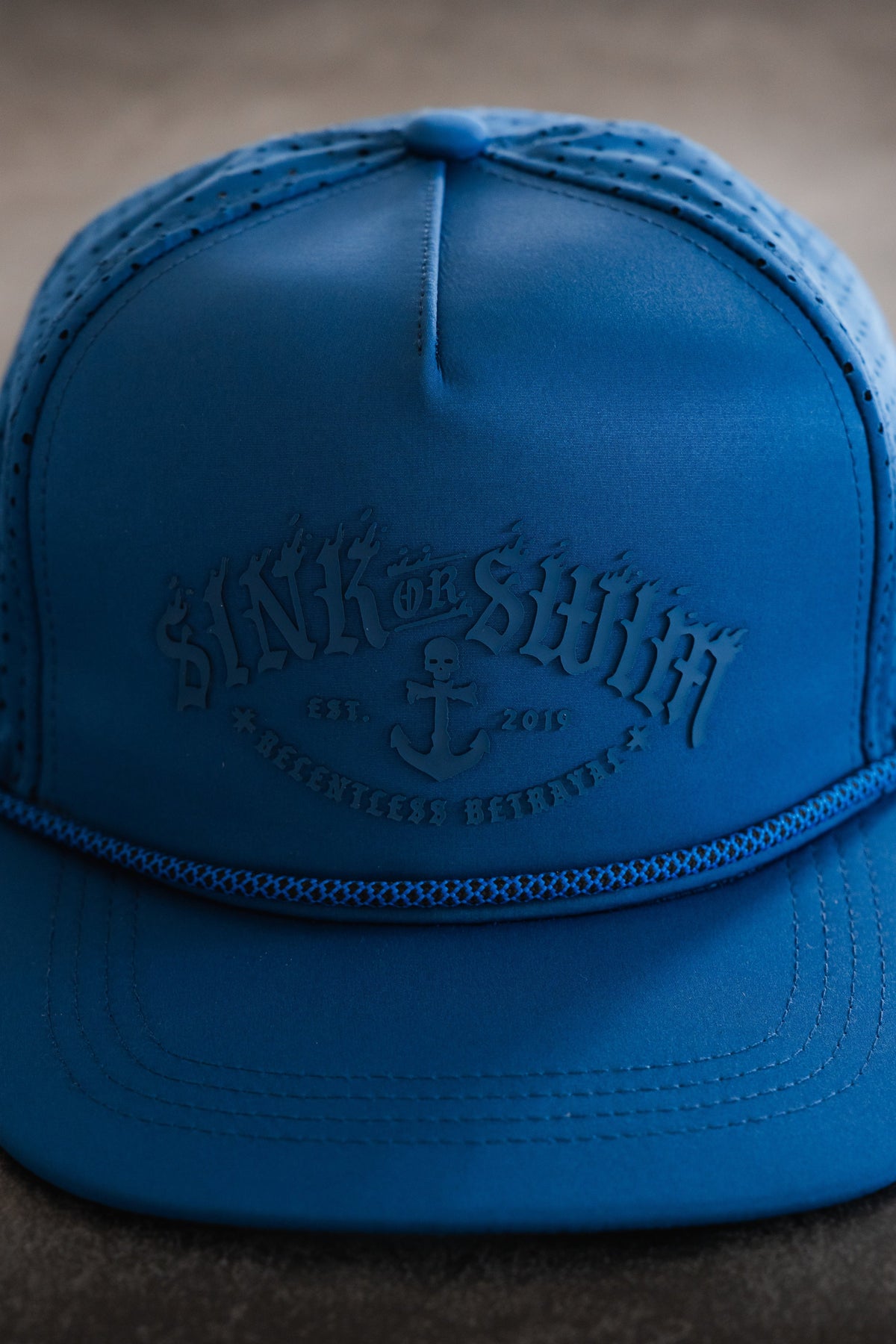 Relentless Betrayal Dark Waters SOS Mute PVC snapback hat with a flat brim and embroidered logo, black color, front view.