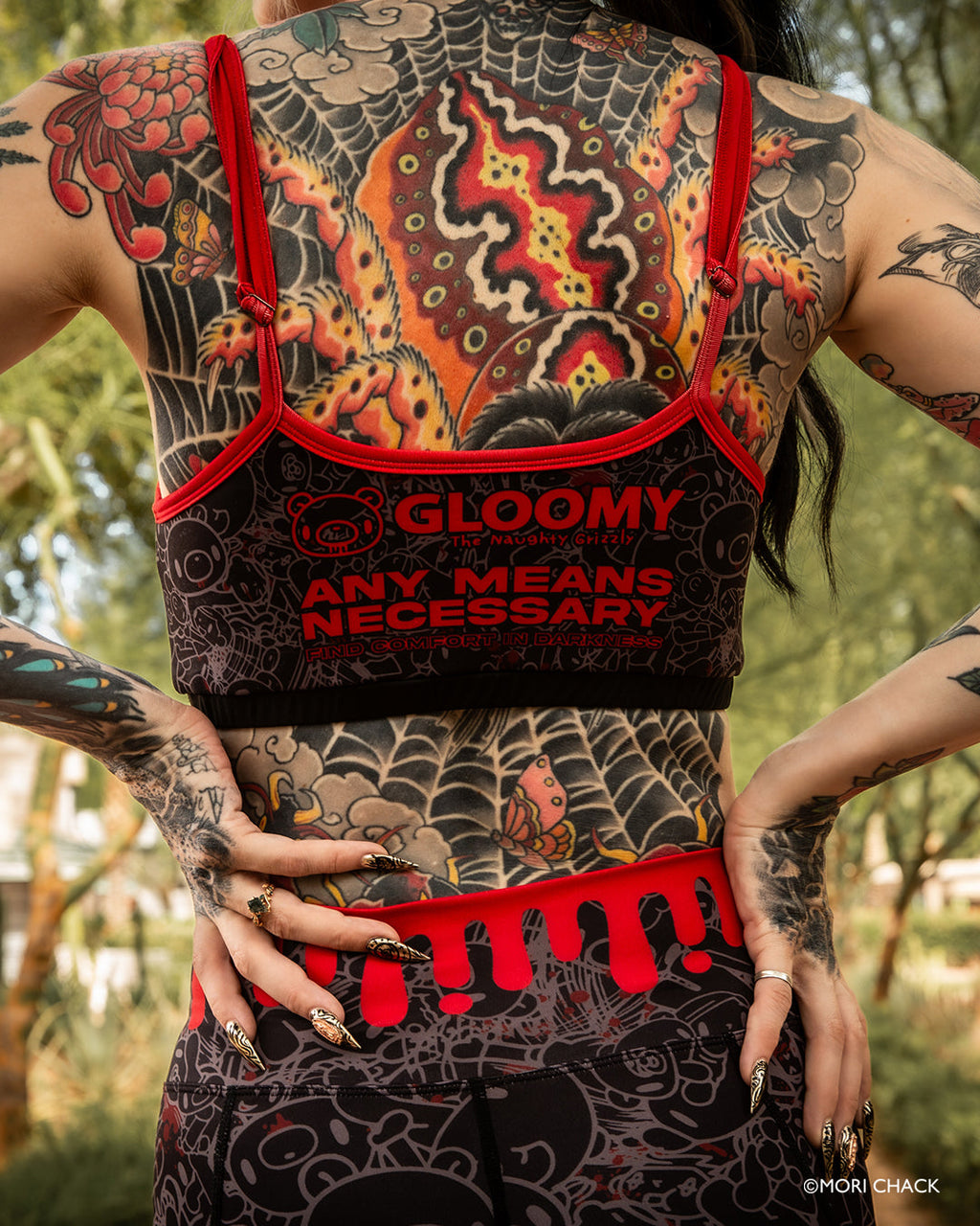 Dark fitness sports bra with blood drip design from Any Means Necessary Clothing, featuring a sleek, supportive athletic bra for active wear.