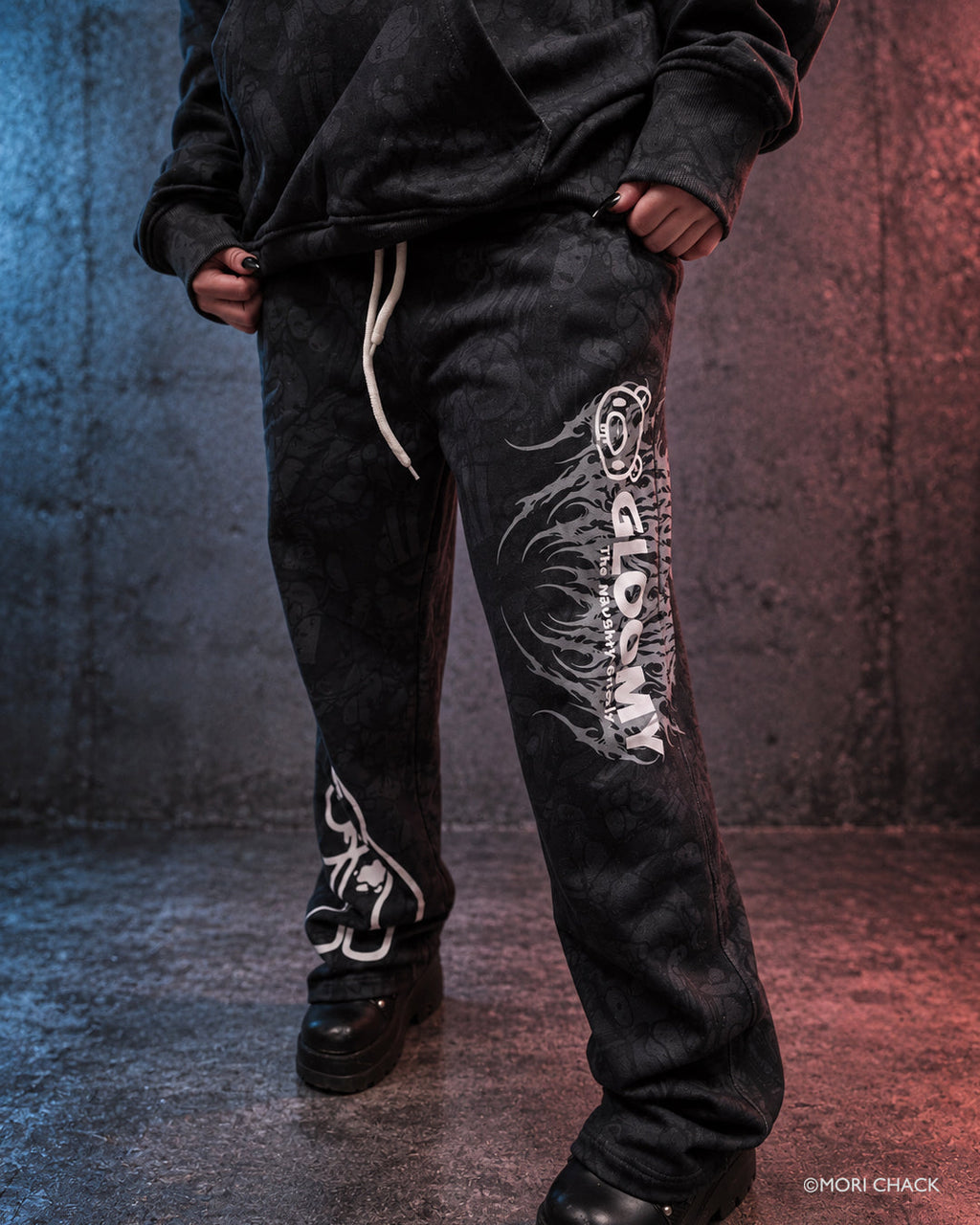 Black Brawl Women's Sweatpants by Any Means Necessary Clothing, featuring a relaxed fit and casual style in a moody, urban setting.