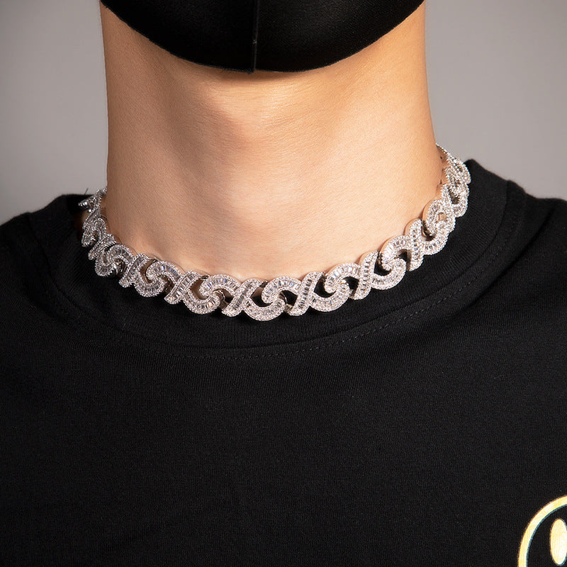 15mm diamond-cut geometric infinity Cuban chain by nowadaysfashion showcasing a shiny, textured gold-tone jewelry piece.